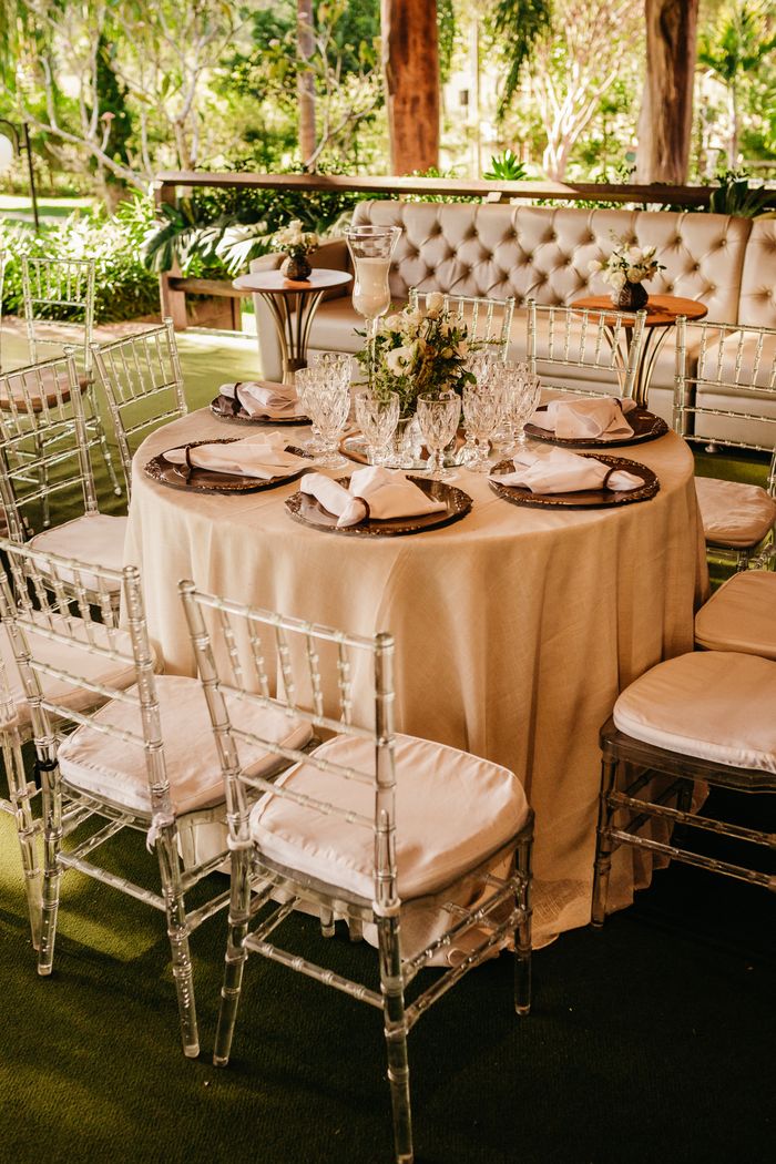 Beautifully arranged outdoor dining table set for an elegant garden event.